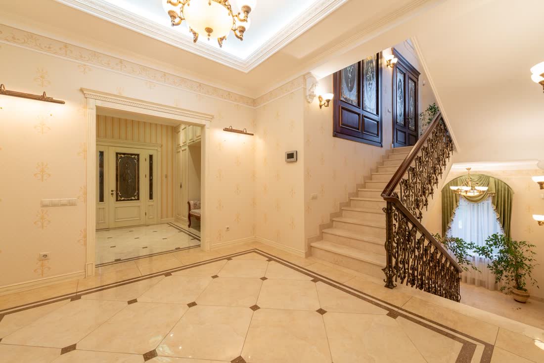 A quiet hall with stairs in warm daylight