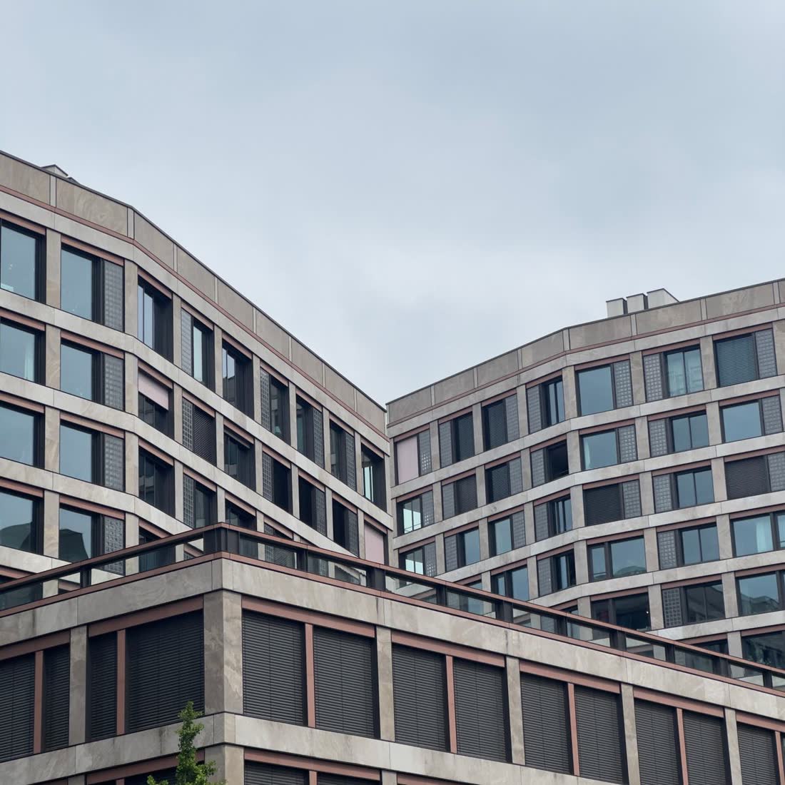 A building facade of repeating bays in late light