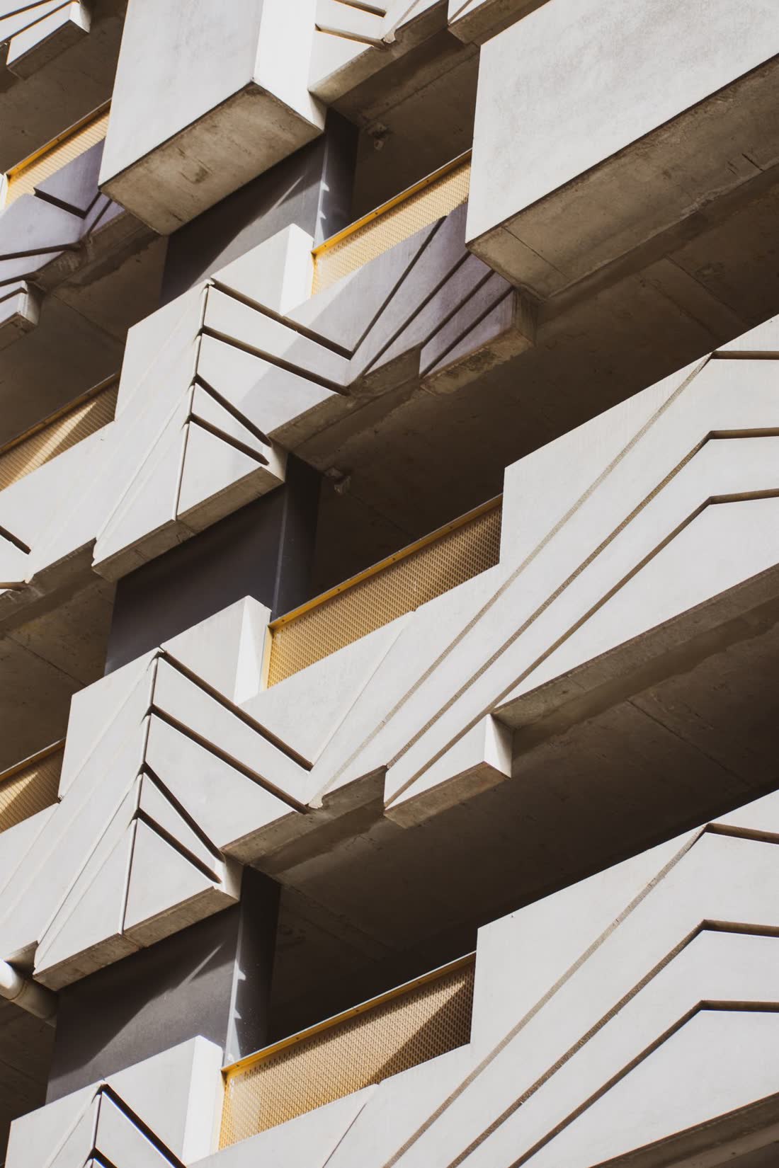A detail of a concrete facade in raking light